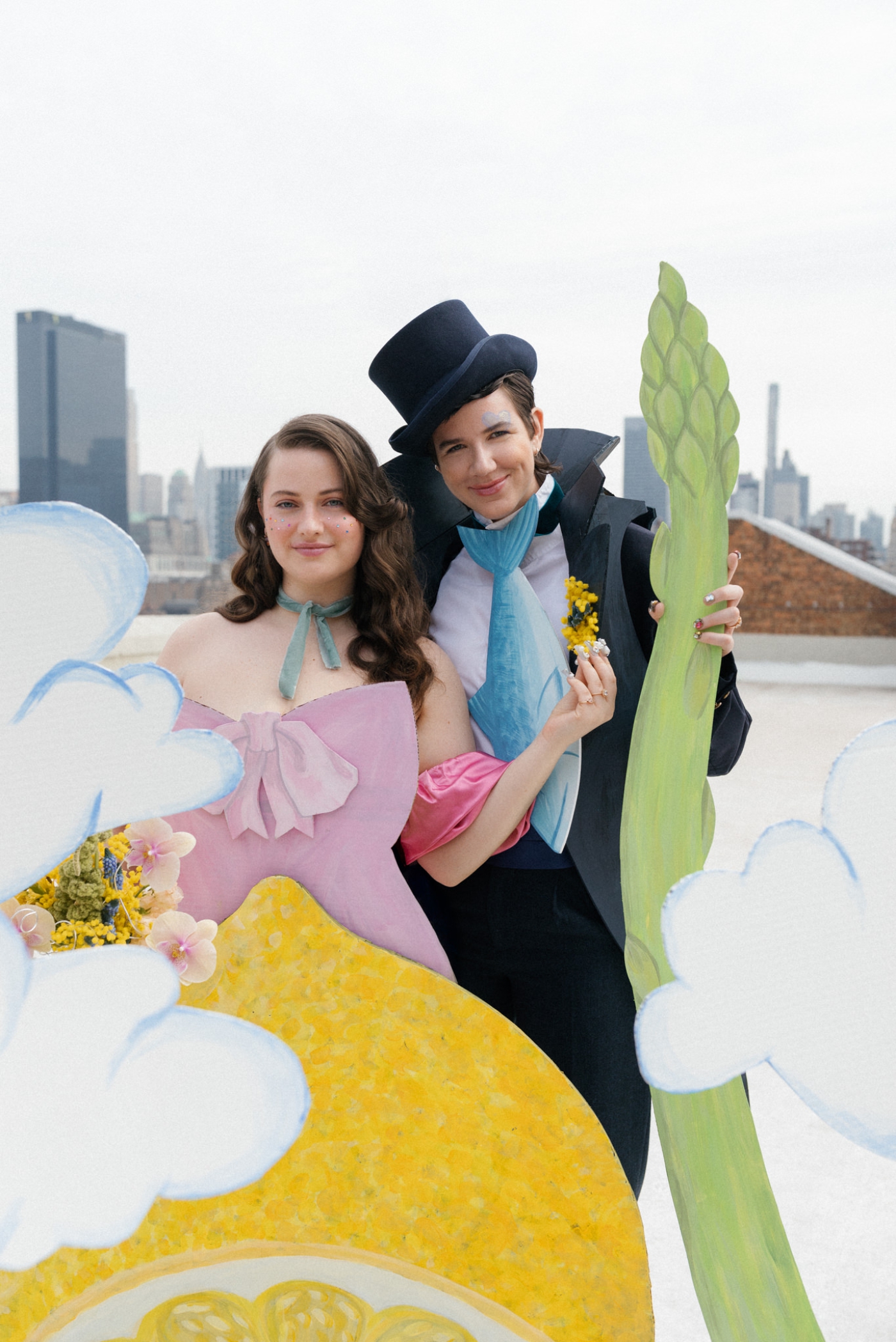 A surreal wedding portrait of two people in 2D clothing holding an asparagus cane